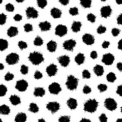 Hand-drawn black spots vector seamless pattern.  Splashes of black paint repeated on white background. Creative surface art for printing on various surfaces or usage in graphic design projects.