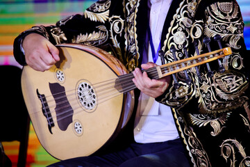 Bukhara, Uzbekistan - June 19, 2023: Musician in Suit Playing Guitar