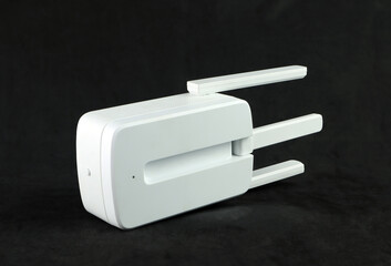 an range extender or repeater is put on black table, device that boosts a communications signal to...