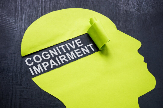 Cognitive impairment concept. Paper head with a torn piece.