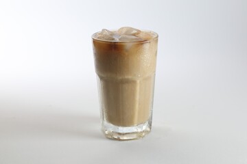 Iced coffee in glass on white background