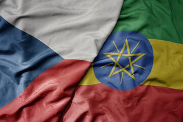 big waving national colorful flag of ethiopia and national flag of czech republic.