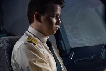 Young captain exudes air of quiet confidence during flight. Man mind sharp and senses attuned to...