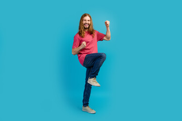 Full body photo of delighted overjoyed man raise fists shout yes empty space isolated on blue color background