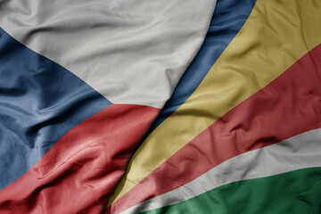 big waving national colorful flag of seychelles and national flag of czech republic.