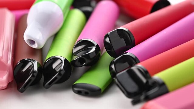 Set Of Colorful Disposable Electronic Cigarettes Of Different Shapes On A White	