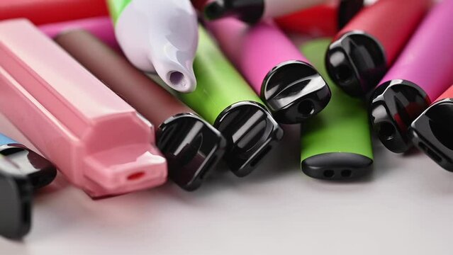 Set Of Colorful Disposable Electronic Cigarettes Of Different Shapes On A White