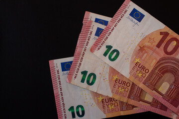 10 euro bills on black background. Closeup photo.