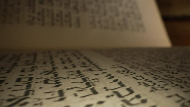 Journey through sacred Ketuvim scriptures. Revered texts in macro footage. Old yellowed jewish antique book.