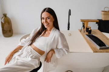 woman dressed in white clothes relaxing in spa