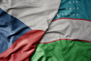 big waving national colorful flag of uzbekistan and national flag of czech republic.