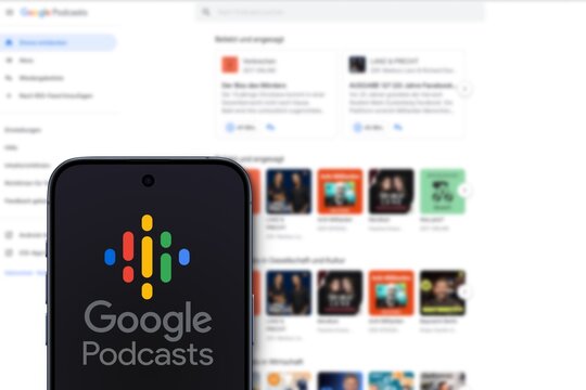 Google Podcasts logo is displayed on a modern smartphone, podcast application developed by Google, website of the service in the background, web version