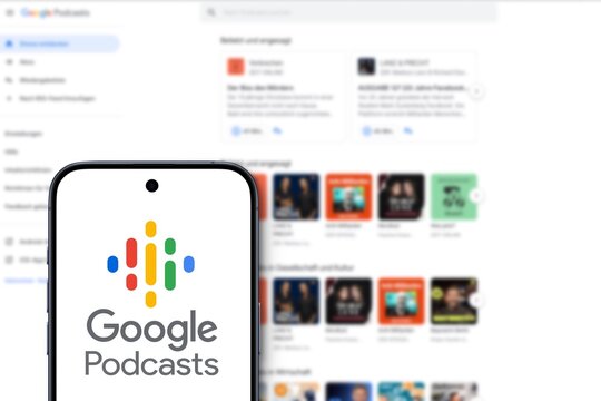 Google Podcasts logo is displayed on a modern smartphone, podcast application developed by Google, website of the service in the background, web version
