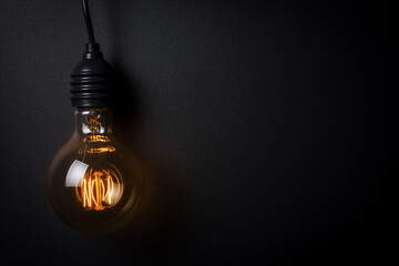 Light bulb on black background. concept idea - obrazy, fototapety, plakaty