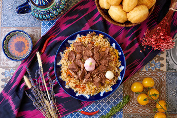 Uzbek food. Pilaf of rice and meat. oriental background