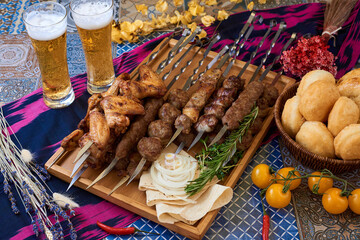 Assorted shish kebab. Beer, barbecue, bread Oriental background
