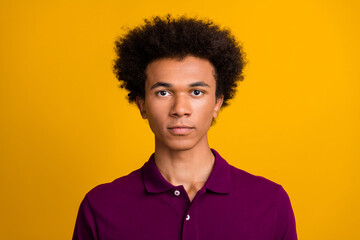 Photo of serious confident man wear purple clothes isolated on vivid yellow color background