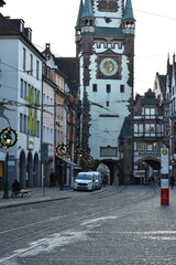 Historic City Gate Tower and Street Decorated with Lights in Freiburg, Germany - 740049192