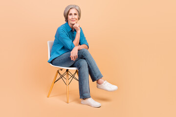 Full length photo of clever thoughtful person wear blue shirt jeans sitting on chair on interview...