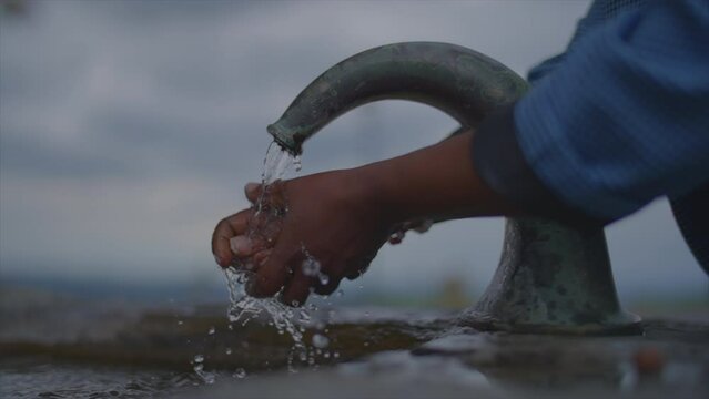 Close-Up of Person Cleaning Hand with Natural Fresh Splashing Running Tap Water