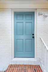 a teal turquoise blue updated and newly painted front door on a home that has just been renovated