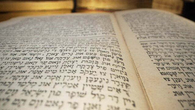 Exploring sacred jewish heritage scriptures on hebrew. Details of the Torah. Tradition and wisdom, macro footage. Letters and symbols.