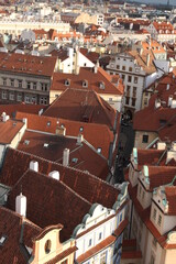 From above, the roofs intertwine like a quilt, varying in color, shape, and age, showcasing the city's diversity and history.