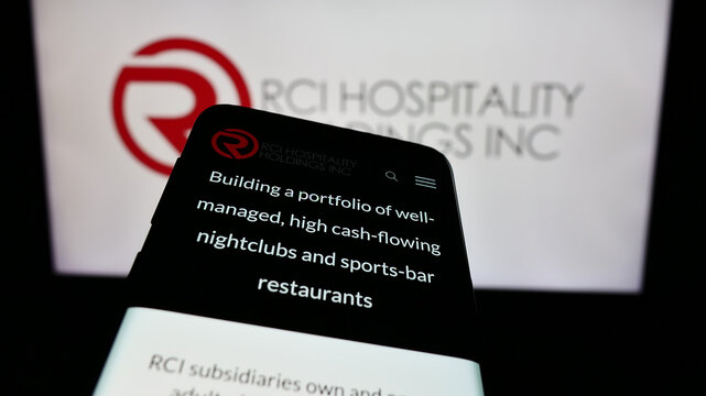 Stuttgart, Germany - 02-11-2024: Mobile phone with website of US nightclub company RCI Hospitality Holdings Inc. in front of business logo. Focus on top-left of phone display.