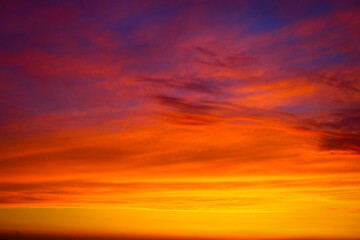 Clouds and different color tones in the sky at sunset. Dance of colors in the sky. Amazing and...