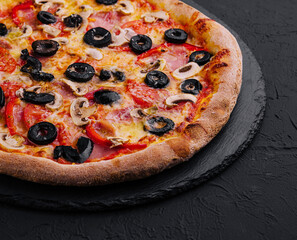 Pizza with tomato, olives, champignons, ham and cheese