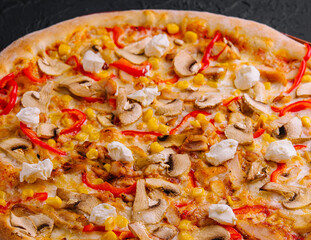pizza with bell peppers, corn, meat and mushrooms closeup