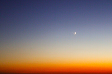 crescent and amazing sky at sunset