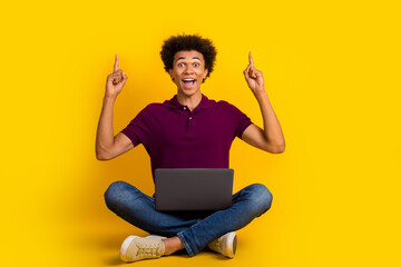 Photo of excited crazy man wear trendy magenta clothes two arms fingers up demonstrate empty space isolated on yellow color background