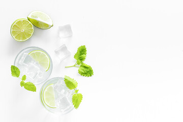 Refreshing cocktail mojito with mint and ice cubes in glasses, top view