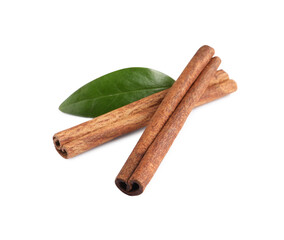Cinnamon sticks and green leaf isolated on white