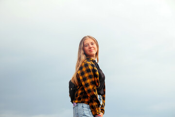 Smiling happy girl. Portrait preteen girl on the gray sky backgr