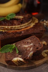 Delicious banana bread on brown table, closeup
