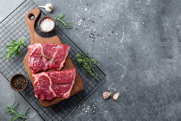 Raw beef chops on a cutting board. Animal product, red meat