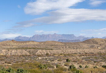 A vast mountainous landscape from the desert of Texas showing a clear blue sky and dry environment. 