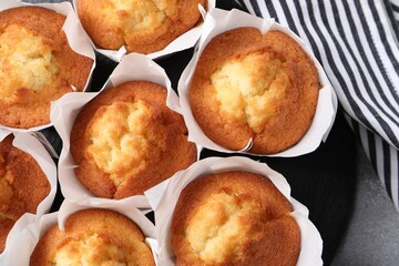 Delicious sweet muffins on grey table, top view