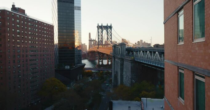 Atmospheric timelapse of sun rising above the iconic Manhattan Bridge and its surroundings