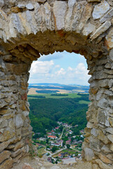 ramka w ramce, ruiny średniowiecznego zamku na górze, partial view from stone window of the ...