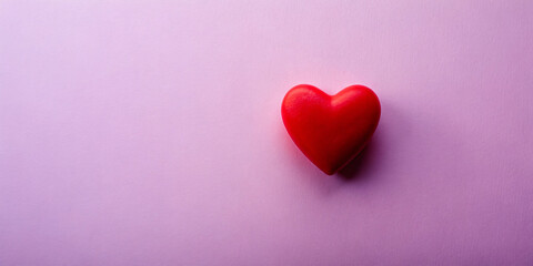 Obraz premium Red heart on purple background, symbolizing love and romance