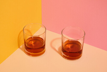 Two whiskey glasses and a party. Celebration party. Night alcohol.