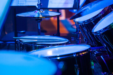 Close-up fragment of percussion instruments in blue stage light