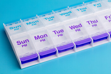 Twice Daily empty weekly pill box on a blue background
