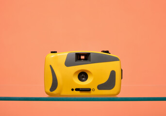 Yellow photo camera. A fun vacation idea for a memory.