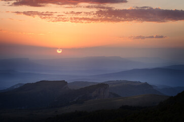 The Colorful sunset over the mountain hills