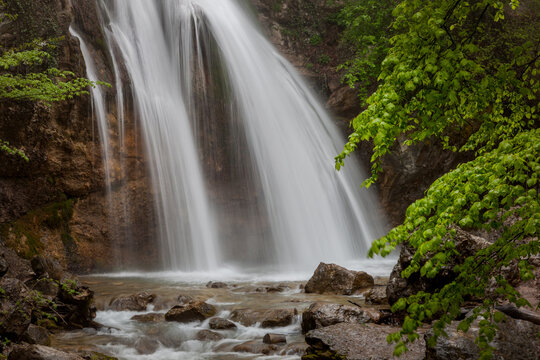 Beautiful waterfall in the forest among green trees