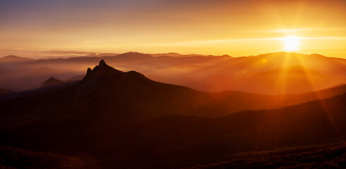 The Colorful sunset over the mountain hills